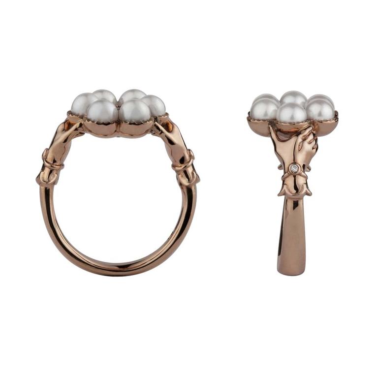 Stephen Einhorn Posey ring in rose gold, set with Akoya pearls and a ruby. Viewed side-on you can see the hands clasping the circle of pearls - a very traditional English design popular in the early 19th century.